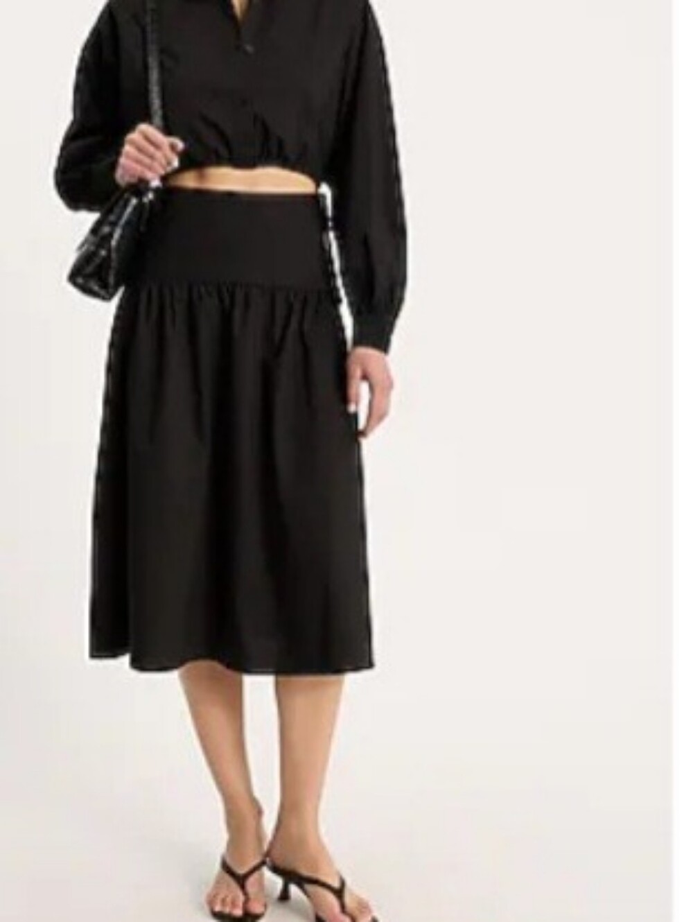 Express Black Two-Piece Set with Connecting Crop Top & Midi Skirt.